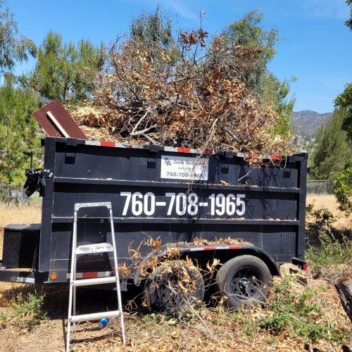 SA Junk Haul trailer loaded with yard waste and debris removal project in San Marcos, CA