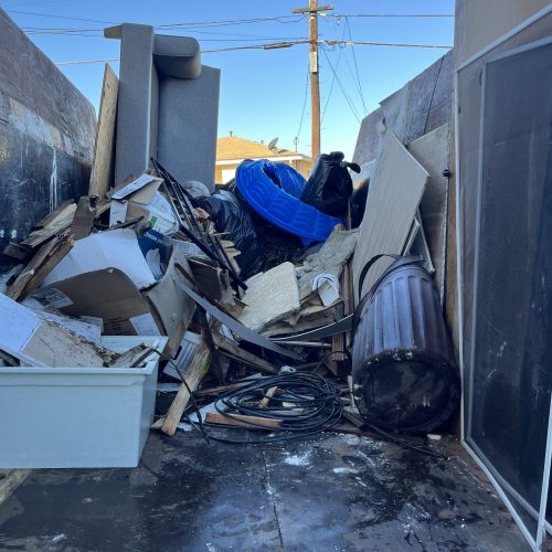 Residential junk removal in San Marcos CA removing furniture, household debris, and unwanted items from a property cleanout